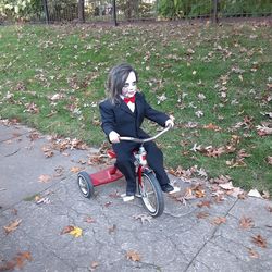 Man riding bicycle on autumn leaves