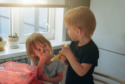 Side view of mother and daughter at home