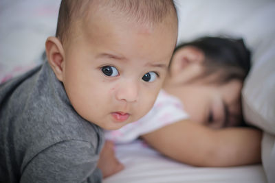 Portrait of cute baby boy on bed