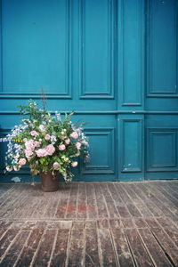 Flowers on wooden door of building