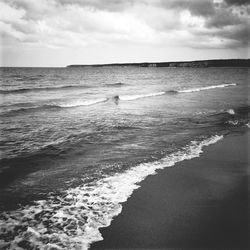 Scenic view of sea against cloudy sky