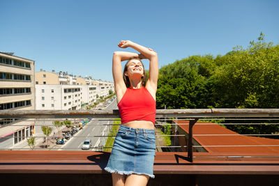 Full length of woman standing against clear sky