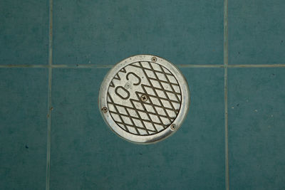 Directly above shot of manhole on tiled floor