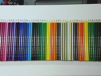 High angle view of colored pencils arranged on table