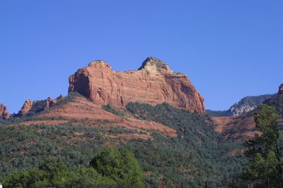 Scenic view of mountains against clear blue sky