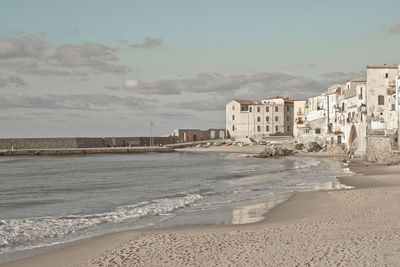 Scenic view of beach against sky in city