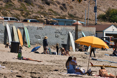 People on beach against buildings