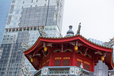 Low angle view of temple against building