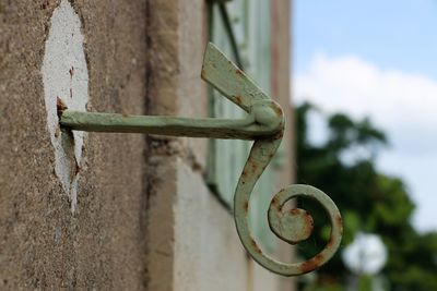 Close-up of rusty metal against wall