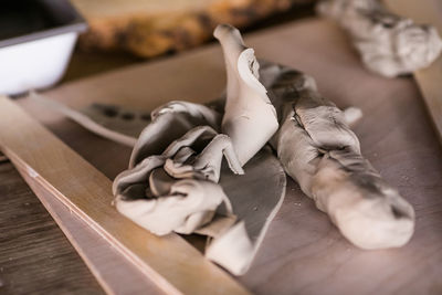 Cropped hand of person cutting board