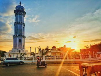 View of buildings in city during sunset