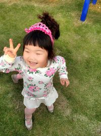 Girl playing on grassy field