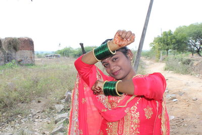 Portrait of smiling woman standing on land