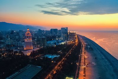 High angle view of illuminated buildings against sky at sunset