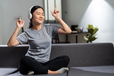Young woman using mobile phone at home