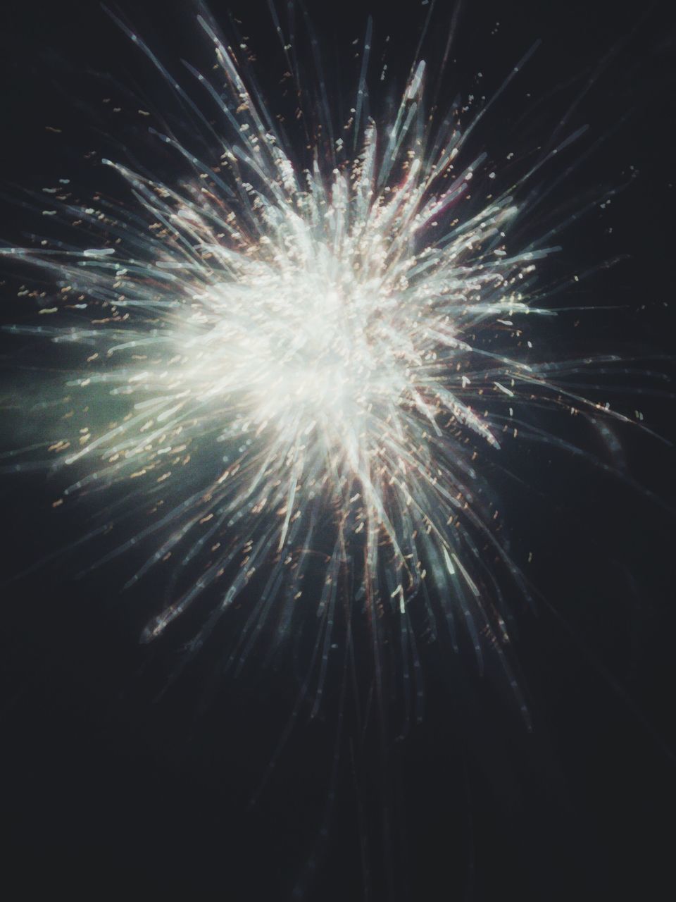 night, firework display, motion, long exposure, exploding, low angle view, glowing, celebration, firework - man made object, arts culture and entertainment, illuminated, event, sparks, blurred motion, firework, entertainment, outdoors, no people, dark, sky