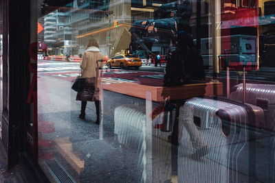 People on street seen through glass window