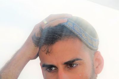 Close-up portrait of young man against white background