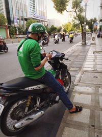 Man riding bicycle on street in city