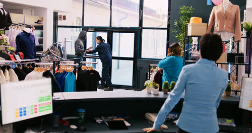 Rear view of people working in gym