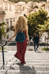 Rear view of woman walking on street in city