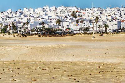 View of beach against buildings in city