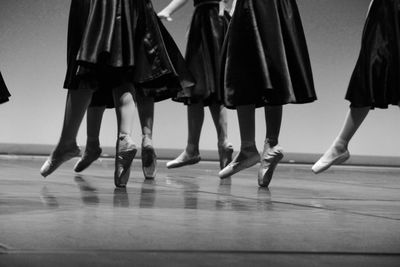 Low section of ballet dancing on floor
