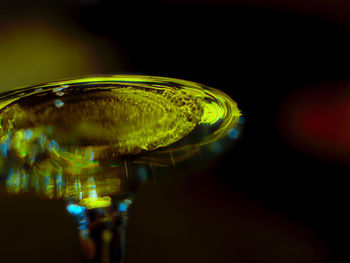 Close-up of glass of water over black background