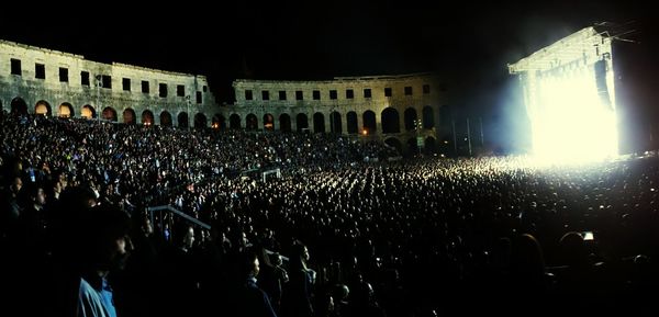 People enjoying music concert at night