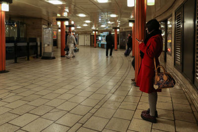 Full length of woman standing on illuminated floor