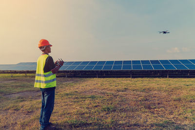 Man working on field against sky