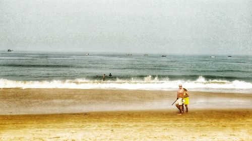 Full length of woman on beach against sky