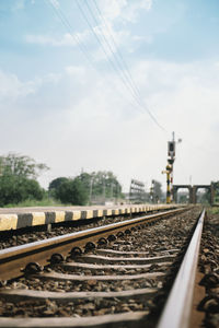 Train on railroad tracks against sky