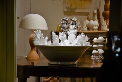 Close-up of illuminated lamp on table at home