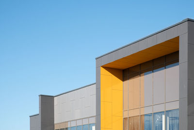 Low angle view of building against clear blue sky