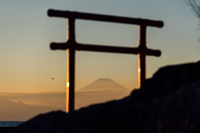 Close-up of silhouette mountains against sky during sunset