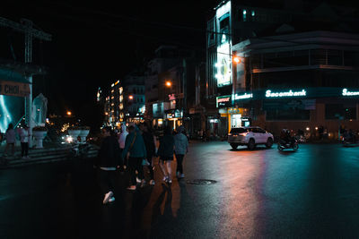 People on city street at night