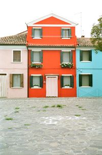 Exterior of house by building against sky