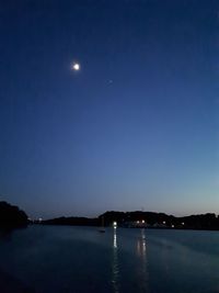 Scenic view of sea against clear sky at night