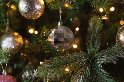 Close-up of christmas decorations hanging on tree