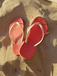 High angle view of red umbrella on sand