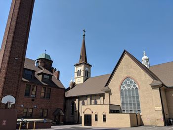 Low angle view of buildings against blue sky