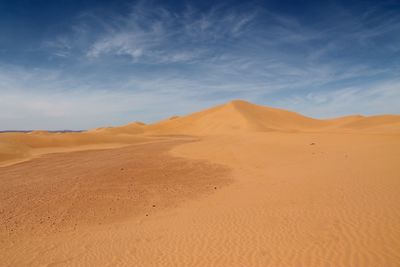 Scenic view of sahara desert against blue sky