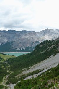 Scenic view of mountains against cloudy sky