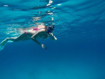 Close-up of woman snorkeling underwater