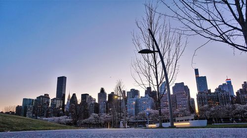 Modern buildings in city against clear sky