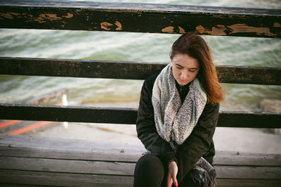 Young woman sitting outdoors