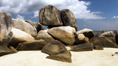 Rocks on beach against sky