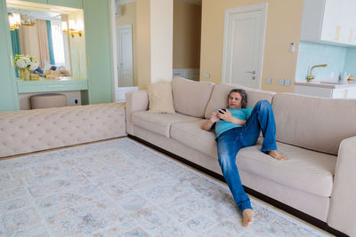 Man sitting on sofa at home