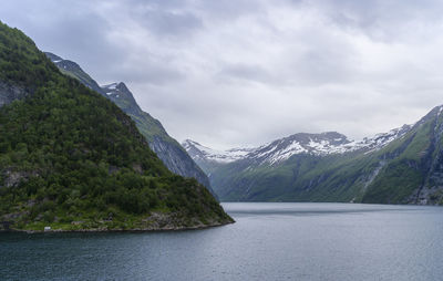 Scenic view of sea and mountains against sky